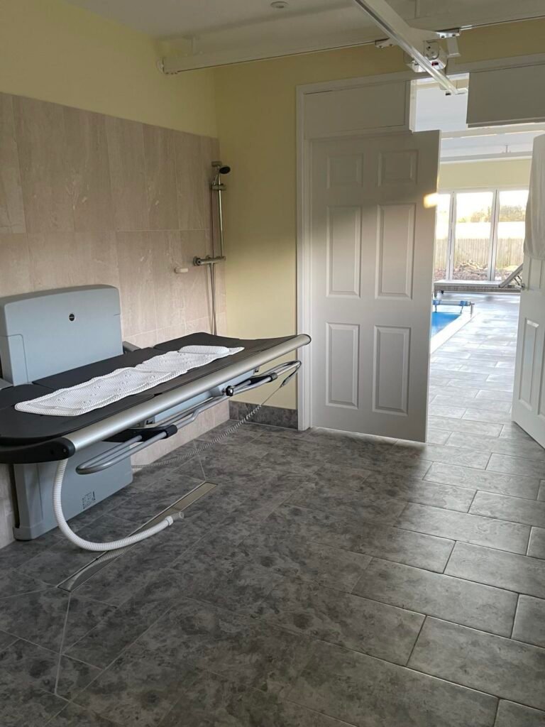 Accessible changing area with ceiling track hoist for safe, supported transfers